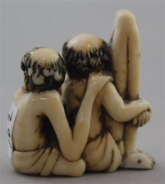 A Japanese ivory netsuke of seated Ashinaga and Tenaga, Meiji period, 3.7cm, repair to one foot